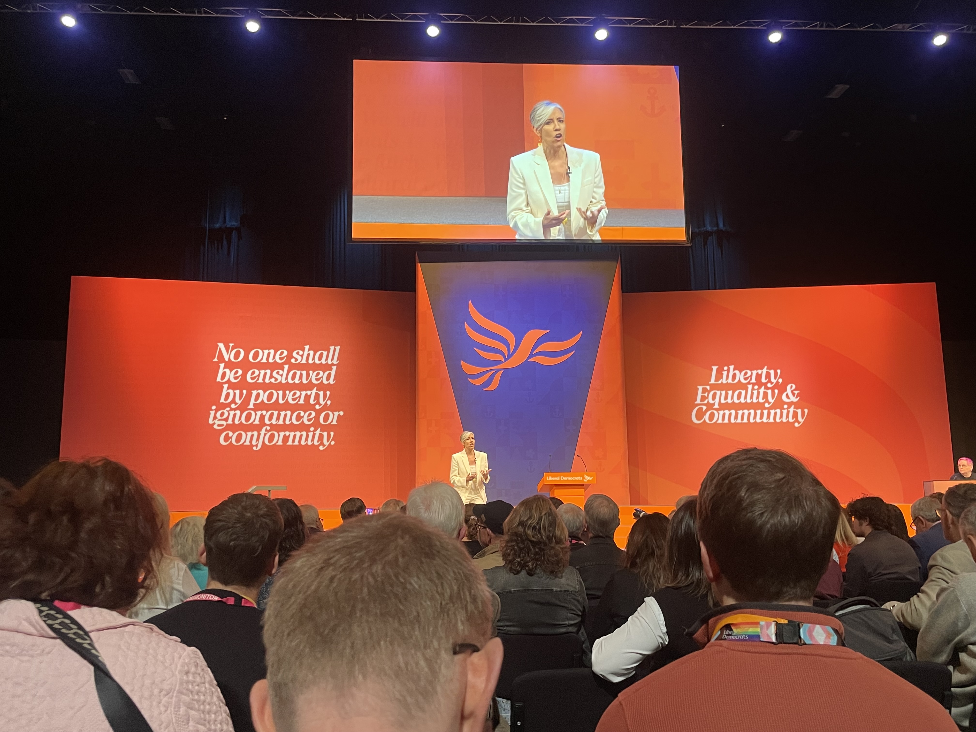 Daisy Cooper presenting on stage