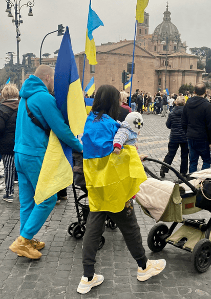Family Pushing Buggies Wrapped In Ukrainian Flag Thumbnail