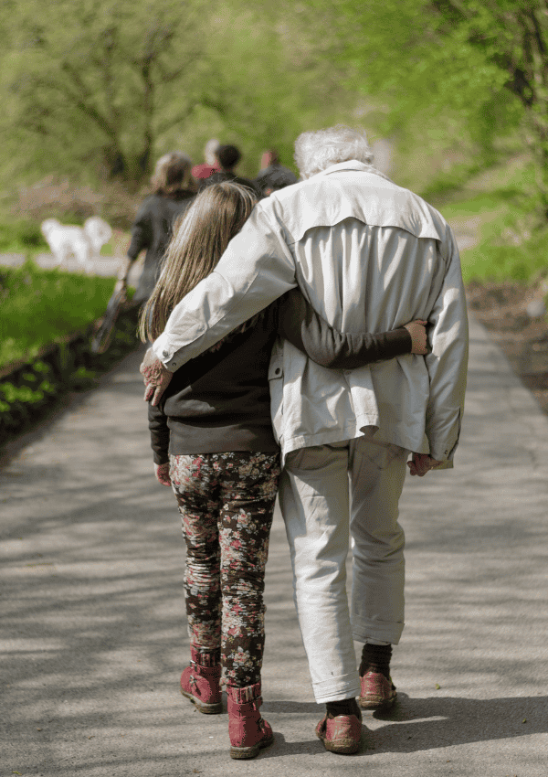 Elderly Man And Young Woman Walking Away Arm In Arm EU Resettlement Scheme Family Thumbnail (2)