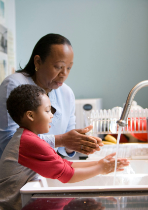 Mother And Son Washing Their Hands Immigration Rules Care Workers Family Thumbnail (1)